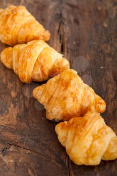fresh croissant french brioche over old wood table 