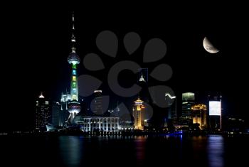 shanghai skyline by night with moon