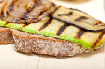 grilled vegetables on rustic  bread over wood table