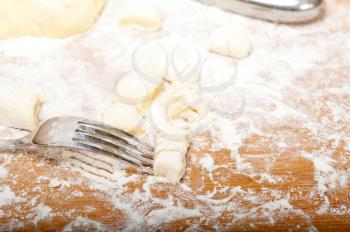 making fresh Italian potato gnocchi on a wood rustic table
