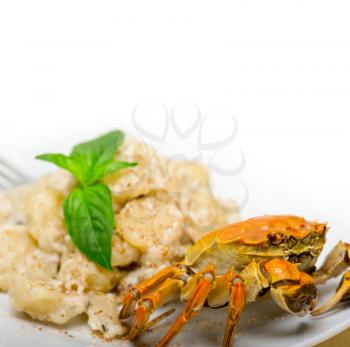 fresh homemade Italian gnocchi with seafood sauce crab and basil