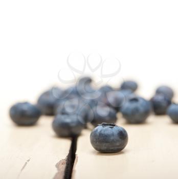 fresh blueberry on white rustic wood table macro