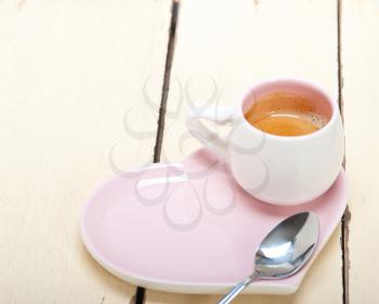 espresso coffee  served on a pink heart shaped dish