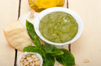 Italian traditional basil pesto sauce ingredients on a rustic table