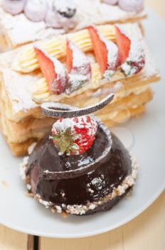 selection of fresh cream napoleon and chocolate mousse cake dessert plate 
