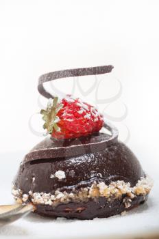 fresh chocolate strawberry mousse over white with silver spoon