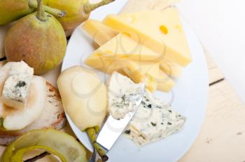 selection of different cheese and fresh pears appetizer snack 
