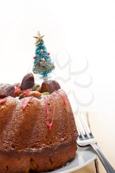 Christmas cake donut with tree as festive decoration on top over white background