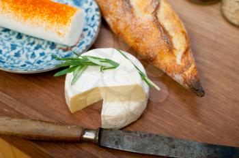 French cheese and fresh  baguette on a wood cutter