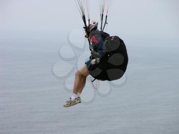 Royalty Free Photo of a Paraglider Suspended in the Air