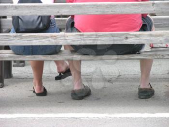 Royalty Free Photo of People Sitting on a Bench