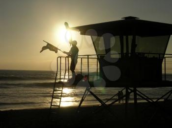 Royalty Free Photo of a Lifeguard Standing on the Tower