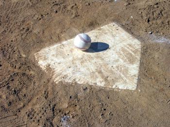 Royalty Free Photo of a Baseball on Home Plate