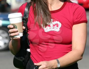 Royalty Free Photo of a Woman Holding a Starbucks Coffee