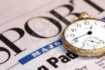 Royalty Free Photo of a Sports Newspaper and Pocket Watch