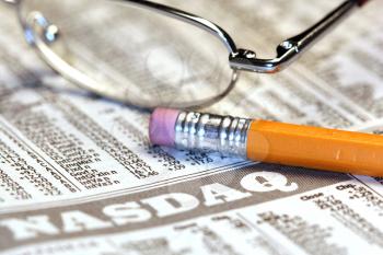Royalty Free Photo of a Pair of Glasses on a Newspaper