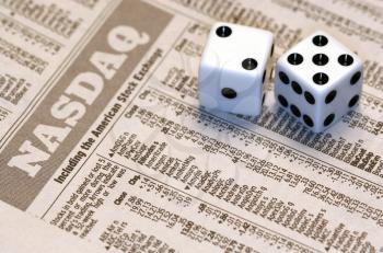 Royalty Free Photo of Dice on a Newspaper