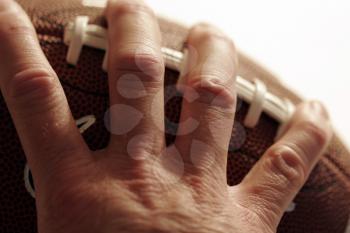 Royalty Free Photo of a Person Holding a Football