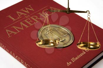 Royalty Free Photo of a Law Book and the Scales of Justice