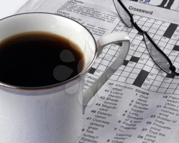 Royalty Free Photo of a Cup of Coffee And Crossword Puzzle