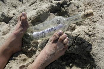 Royalty Free Photo of a Person With a Message in the Bottle