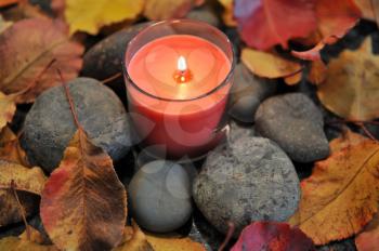 Royalty Free Photo of a Candle and Rocks