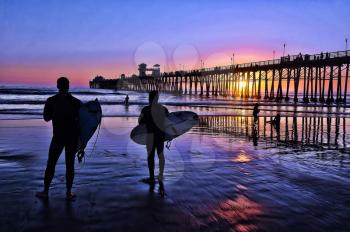 Royalty Free Photo of Surfers at Sunset