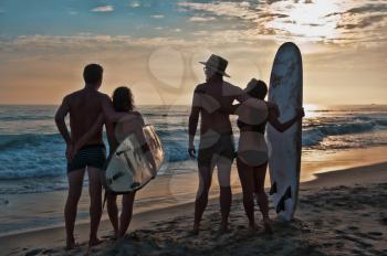Royalty Free Photo of Two Surfer Couples on the Beach