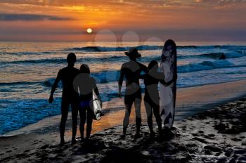 Royalty Free Photo of Two Couples on the Beach at Sunset