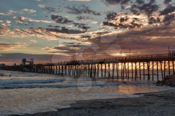 Royalty Free Photo of an Oceanside Pier at Sunset