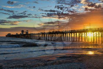 Royalty Free Photo of an Oceanside Pier at Sunset