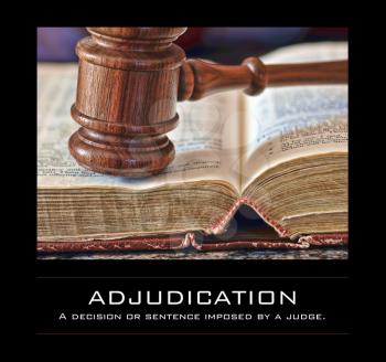 Royalty Free Photo of a Judge's Gavel and Book With the Word Adjudication
