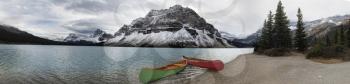 Two canoes on Bow Lake. This is a three image panoramic of Bow Lake. Bow Lake is a small lake in western Alberta, Canada. It is located on the Bow River, in the Canadian Rockies, at an altitude of 192