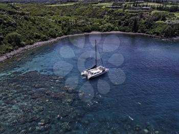 Royalty Free Photo of a Catamaran at Honolua Bay, Maui, Hawaii