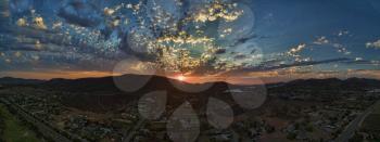 Royalty Free Photo of a Sunset in San Marcos. This is a colorful aerial panoramic at sunset in this North county San Diego, Southern Caliornia town.