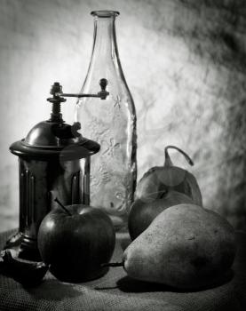 Royalty Free Photo of Fruits, a Coffee Grinder and Bottle