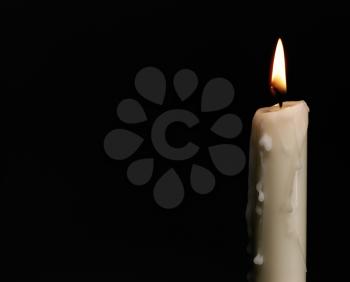 Royalty Free Photo of a Burning Candle on Black