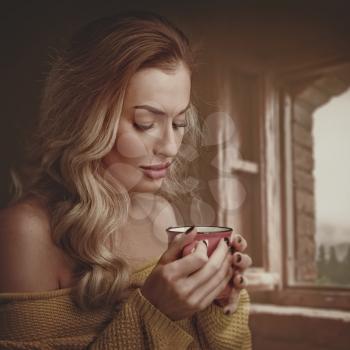 Early morning with scented coffee. Beauty female portrait with cup of drink
