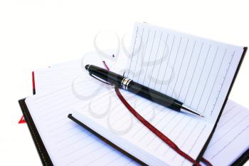 Royalty Free Photo of a Pen on Notebooks