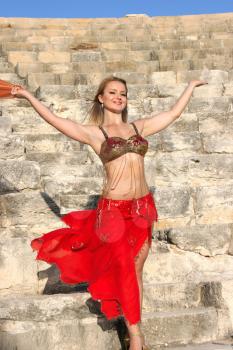Royalty Free Photo of a Belly Dancer on the Stairs of the Kourion Amphitheatre
