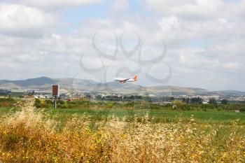 Royalty Free Photo of an Airplane Over Fields in Cyprus