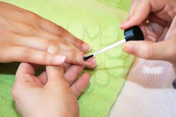 Royalty Free Photo of a Woman Getting a Manicure