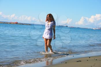 Royalty Free Photo of a Woman Walking on the Beach