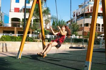 Royalty Free Photo of a Woman on a Swingset
