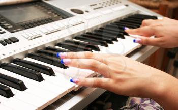 Royalty Free Photo of a Woman Playing the Keyboard