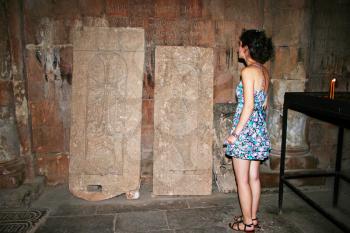 Royalty Free Photo of a Woman Looking at Cross Stones in the Noravank Monastery in Armenia