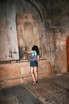 Royalty Free Photo of a Woman Looking at Cross Stones in the Noravank Monastery in Armenia