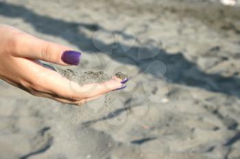 Royalty Free Photo of a Woman Holding Sand