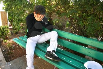 Royalty Free Photo of a Man Crying on a Bench