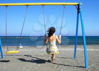 Royalty Free Photo of a Woman Swinging on a Swing Set